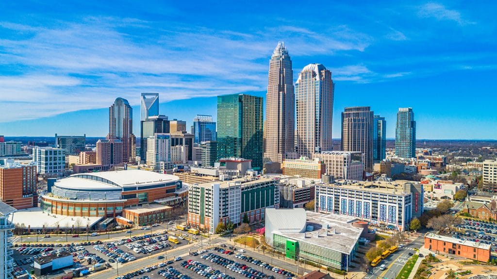 an aerial view of charlotte's skyline against a blue sky