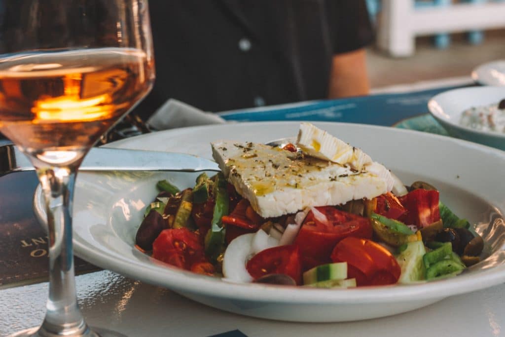 A greek salad topped with feta cheese at a Greek restaurant.